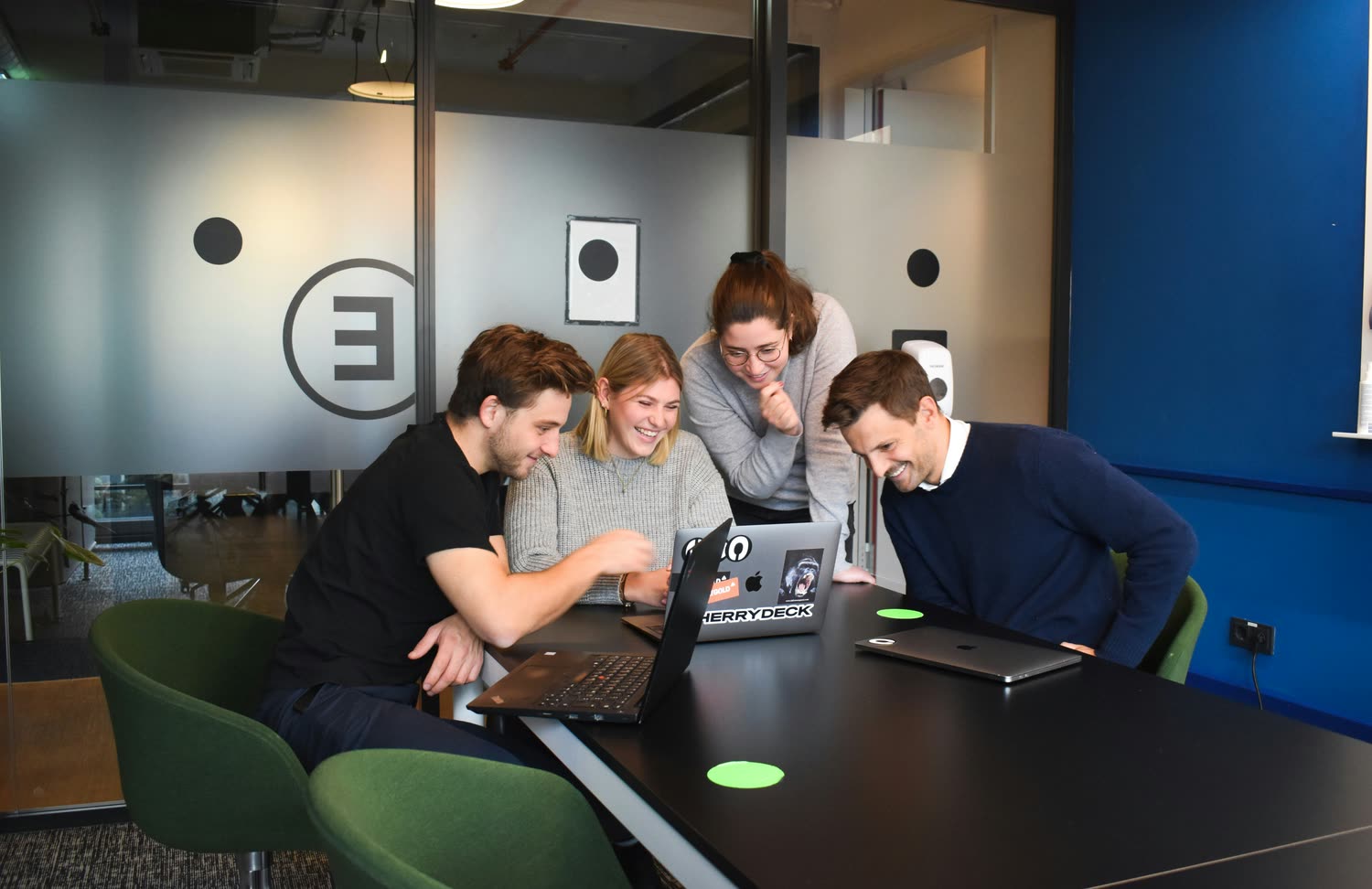 The early Ziora team collaborating around laptops